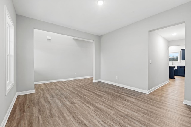 spare room with wood-type flooring and sink