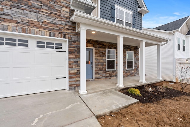 entrance to property featuring a porch and a garage