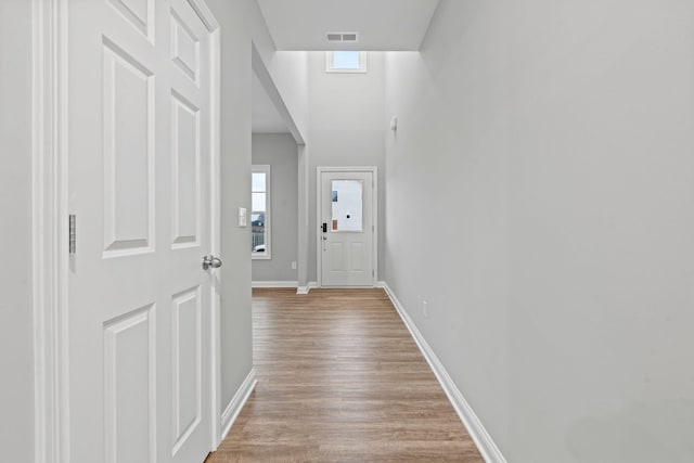 hall with light hardwood / wood-style flooring