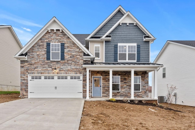 craftsman house featuring central AC unit and a garage