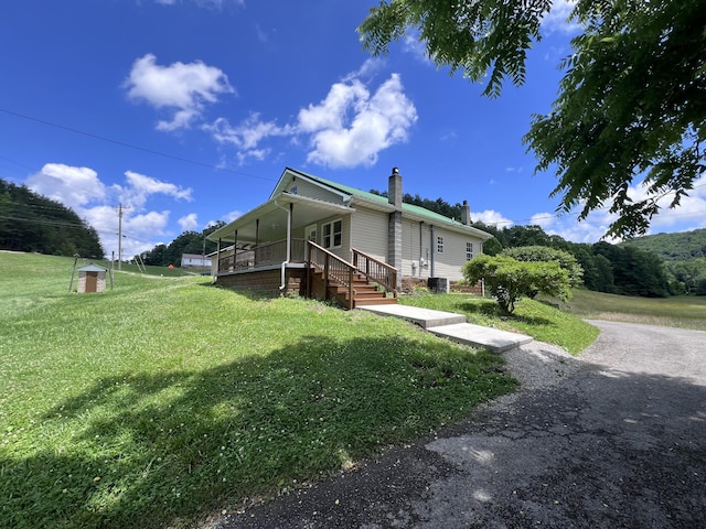 view of property exterior featuring a yard and covered porch