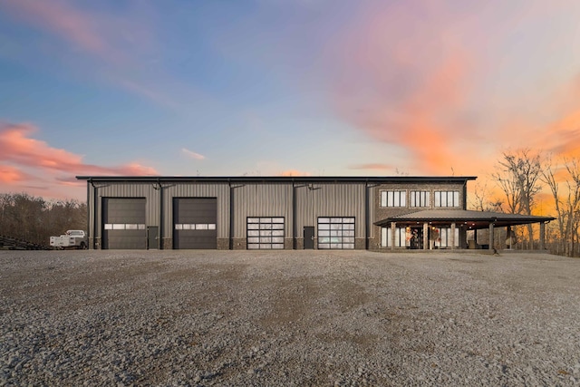 view of garage at dusk