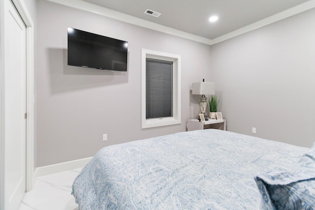 bedroom featuring crown molding and a closet