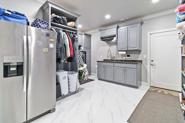 interior space featuring crown molding and sink