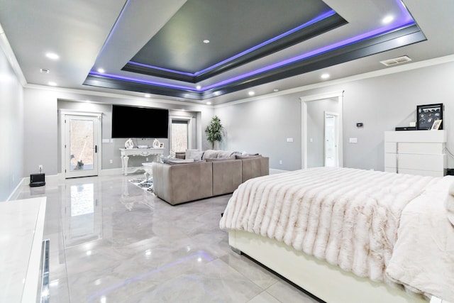 bedroom featuring ornamental molding, multiple windows, and a tray ceiling