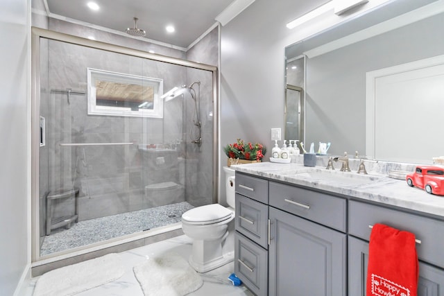 bathroom with vanity, toilet, a shower with door, and ornamental molding