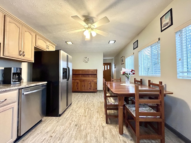 kitchen featuring light brown cabinets, ceiling fan, a textured ceiling, light hardwood / wood-style floors, and stainless steel appliances