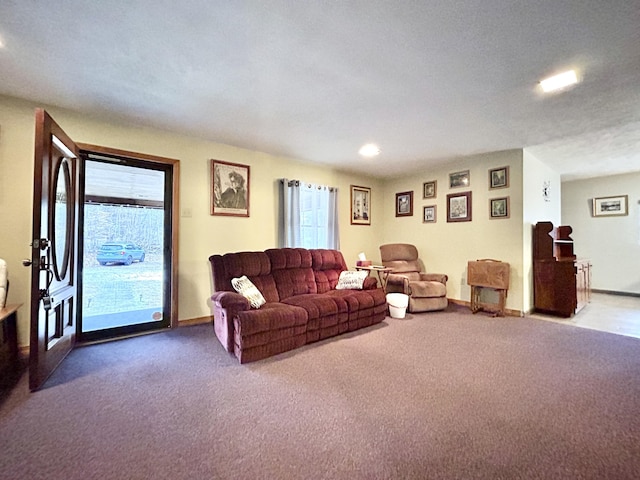 living room with carpet, a textured ceiling, and a wealth of natural light