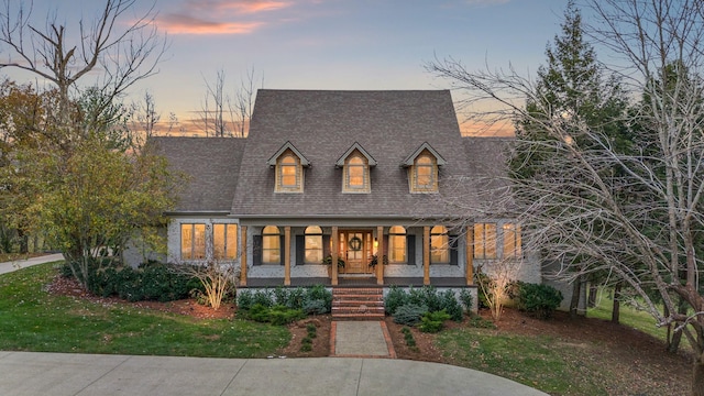 view of front of property featuring a lawn and a porch