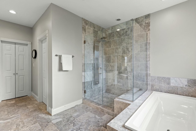 bathroom featuring separate shower and tub