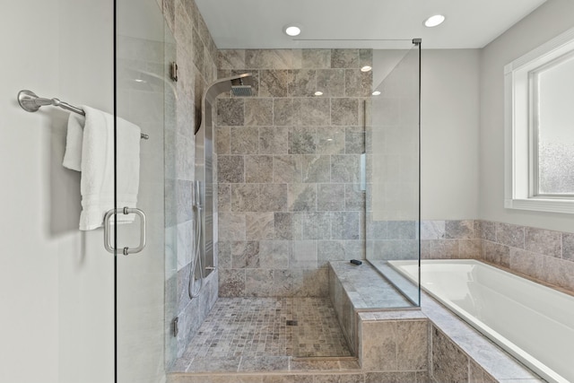 bathroom featuring separate shower and tub