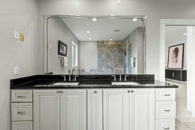 bathroom with a shower and vanity