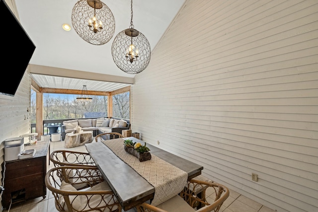 dining room with a towering ceiling and a notable chandelier