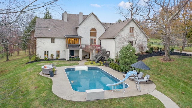 back of property featuring a lawn and a patio