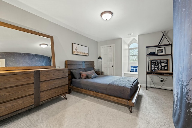 bedroom featuring light carpet, a closet, and lofted ceiling