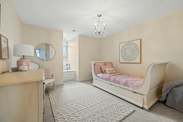 carpeted bedroom with a chandelier