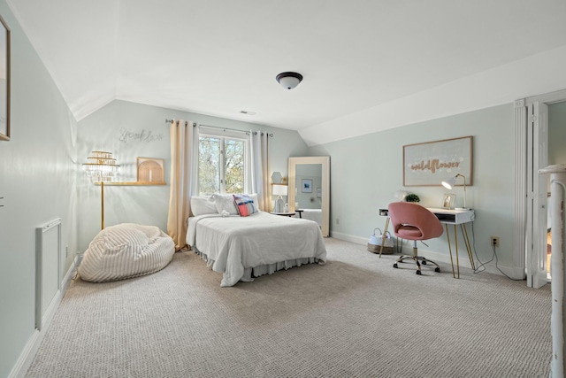 bedroom with light colored carpet and lofted ceiling