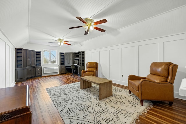 living area with ceiling fan, wood-type flooring, and vaulted ceiling