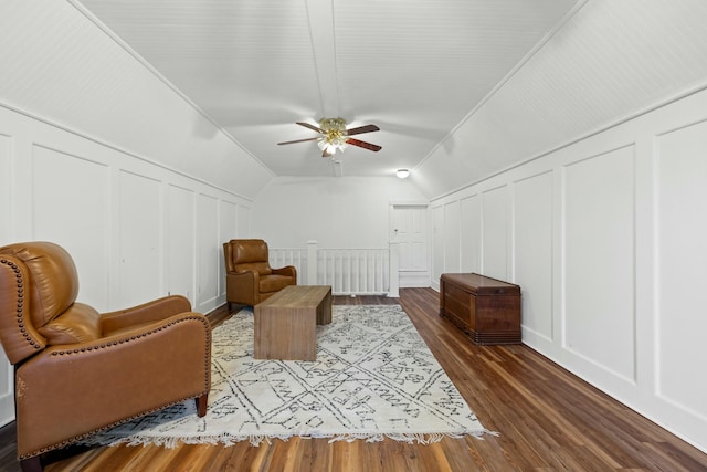 living area with ceiling fan, hardwood / wood-style floors, and lofted ceiling