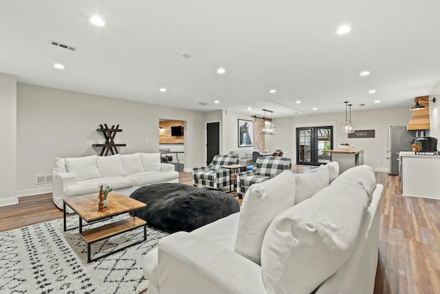 living room with light wood-type flooring and french doors