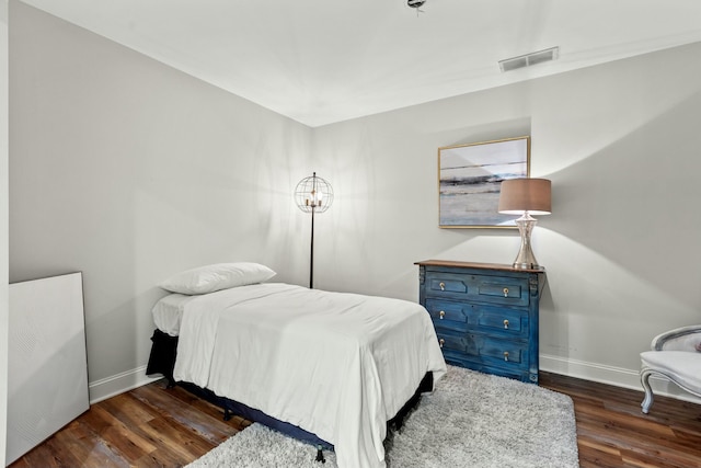 bedroom with dark wood-type flooring