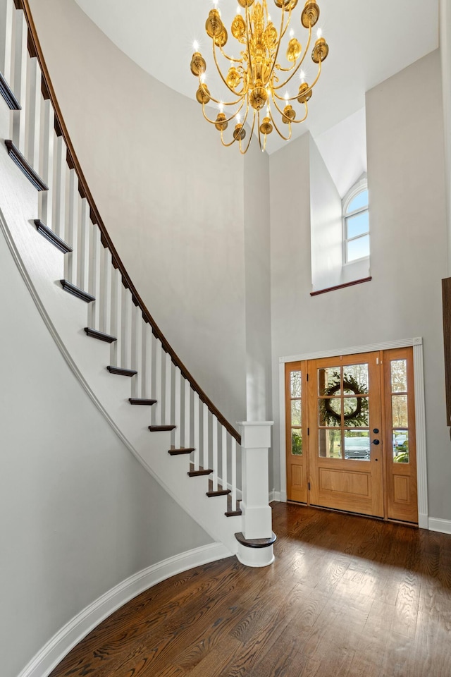 entryway featuring a high ceiling, dark hardwood / wood-style flooring, and a notable chandelier