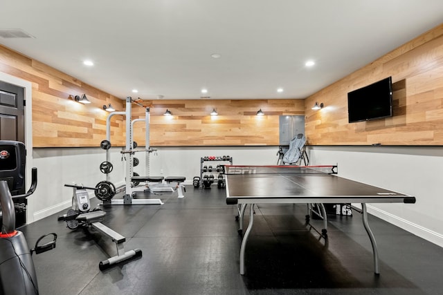 workout area featuring wood walls