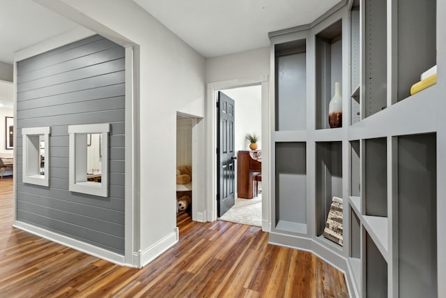 corridor with dark hardwood / wood-style flooring