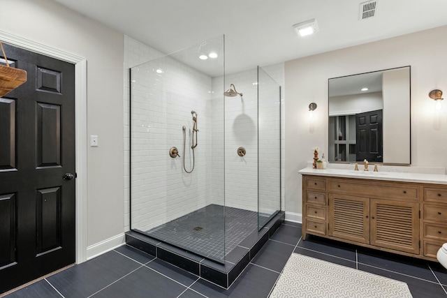 bathroom with tile patterned flooring, vanity, and a shower with door