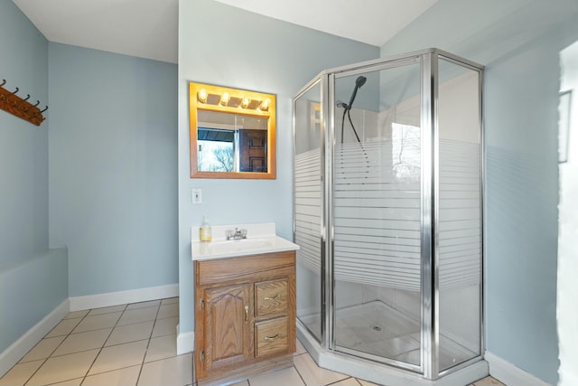 bathroom with tile patterned floors, vanity, and a shower with shower door