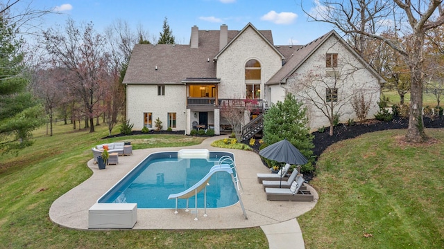 rear view of house with a yard and a patio