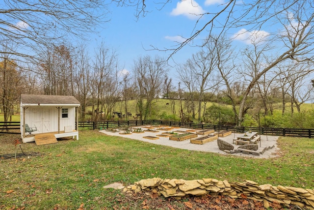 view of yard featuring a rural view and a shed