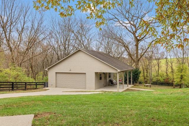 exterior space with a yard, covered porch, and a garage