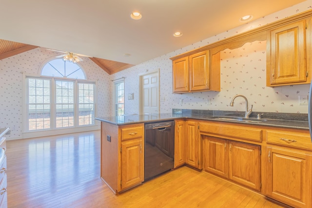 kitchen with kitchen peninsula, light wood-type flooring, vaulted ceiling, sink, and dishwasher