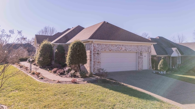 view of front of house with a garage and a front lawn