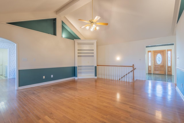 spare room featuring beam ceiling, ceiling fan, hardwood / wood-style floors, and high vaulted ceiling