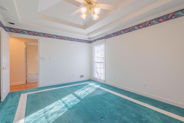 unfurnished room with carpet, a raised ceiling, and ceiling fan