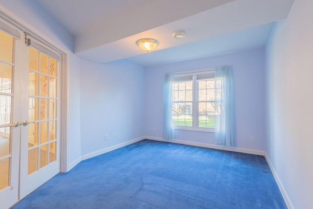 carpeted spare room with french doors