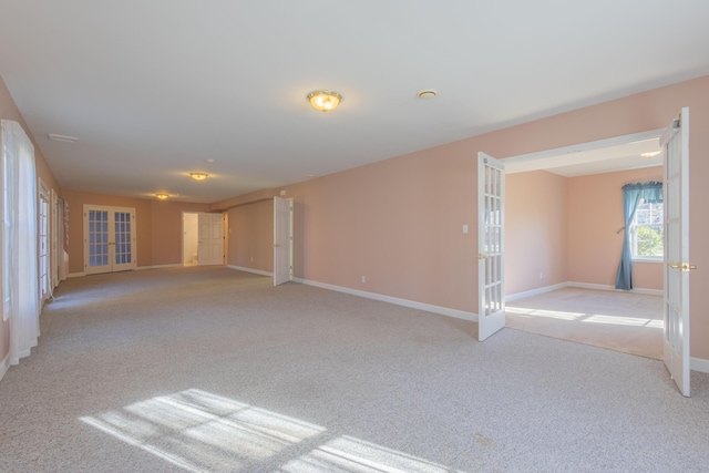 empty room with light colored carpet and french doors