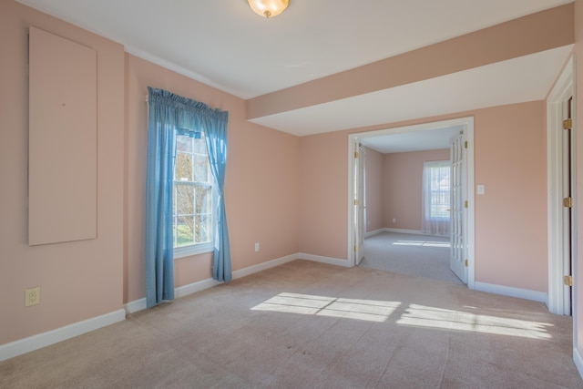 spare room featuring light carpet