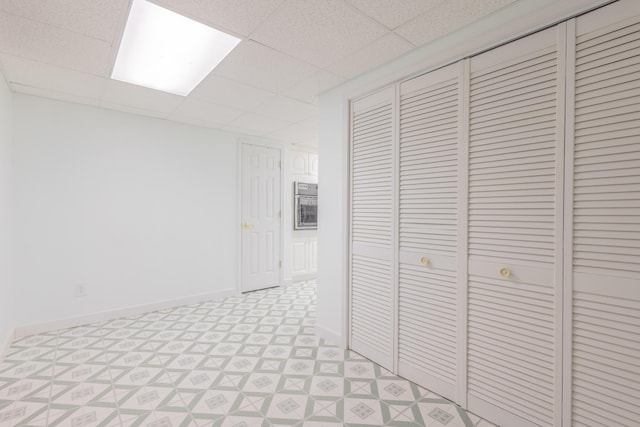 corridor featuring a paneled ceiling