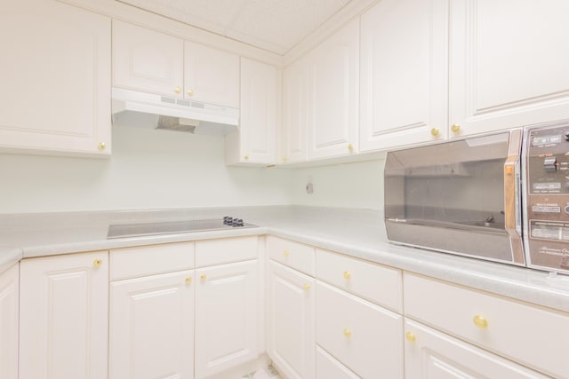 kitchen featuring white cabinetry and electric stovetop