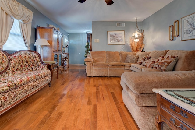 living room featuring ceiling fan and light hardwood / wood-style floors