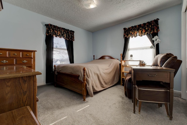 bedroom with a textured ceiling, light carpet, and multiple windows