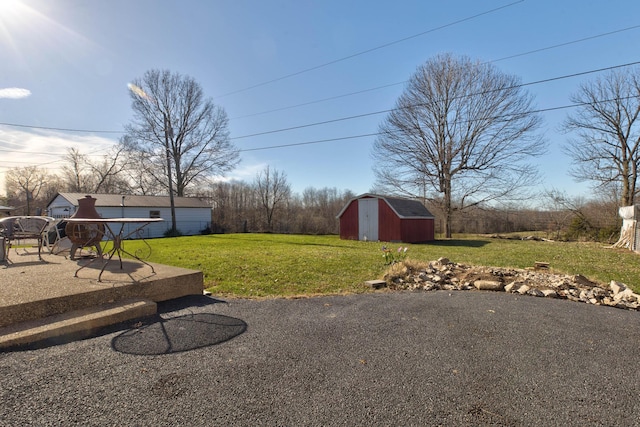 view of yard featuring a patio and a shed