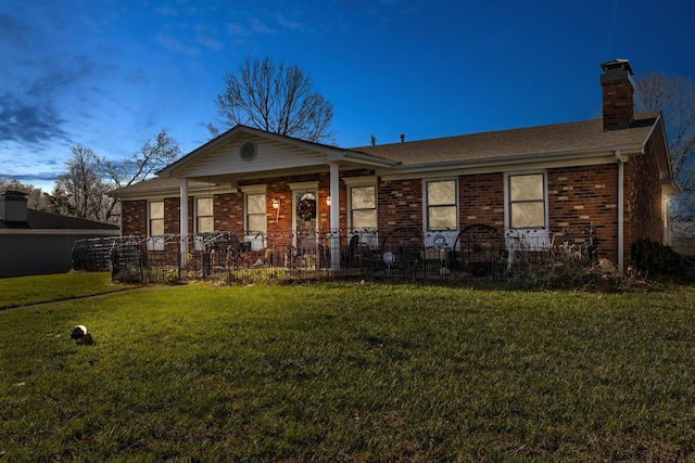 single story home featuring a yard