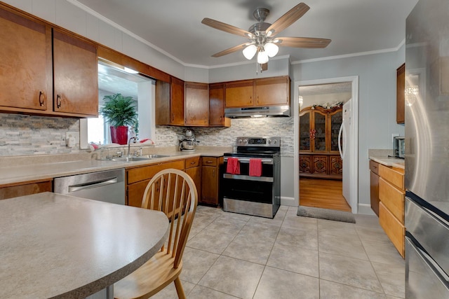 kitchen featuring crown molding, sink, ceiling fan, and stainless steel appliances