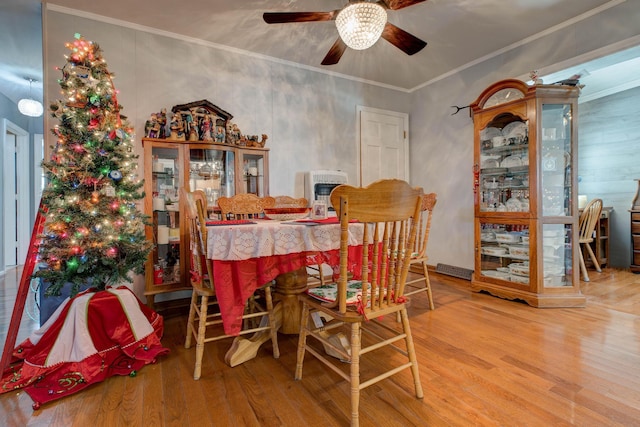 dining space featuring ceiling fan, hardwood / wood-style floors, and ornamental molding