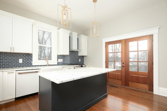 kitchen with french doors, a kitchen island, white dishwasher, pendant lighting, and white cabinets