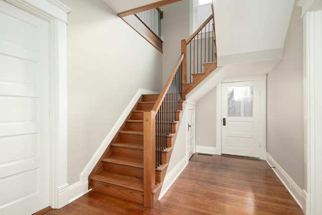 stairs with hardwood / wood-style flooring